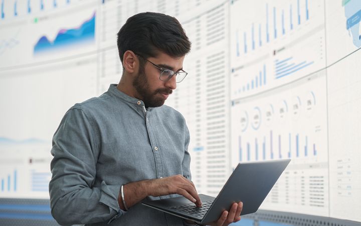 Gentleman working on data and analytics dashboard at work 
