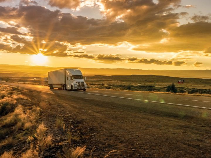 Freight truck driving on desert road